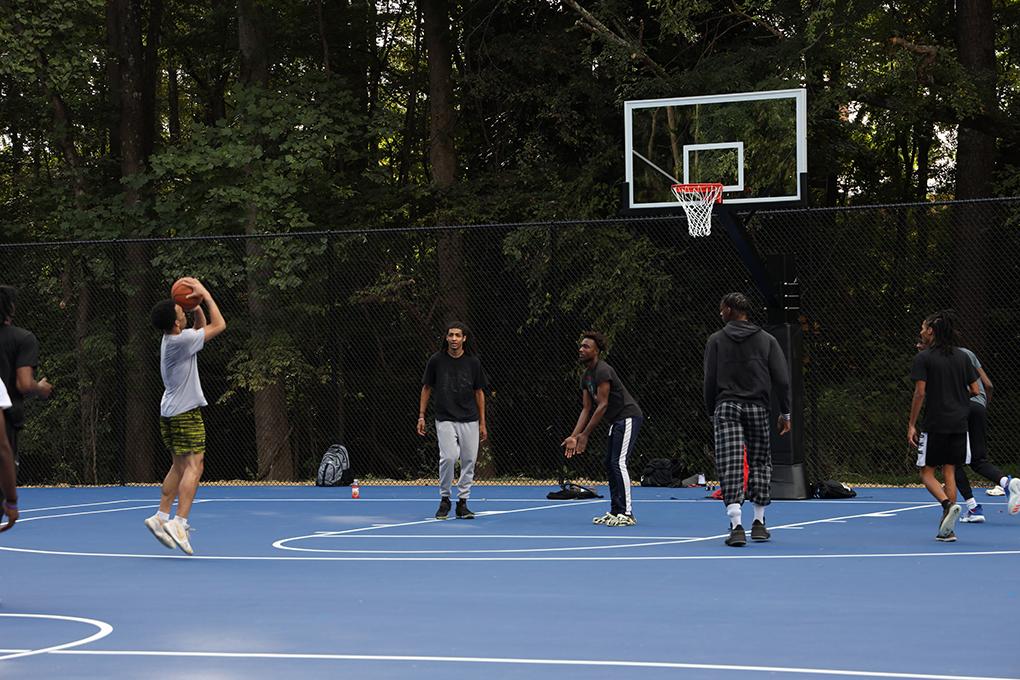 Students playing basketball on outdoor courts.
